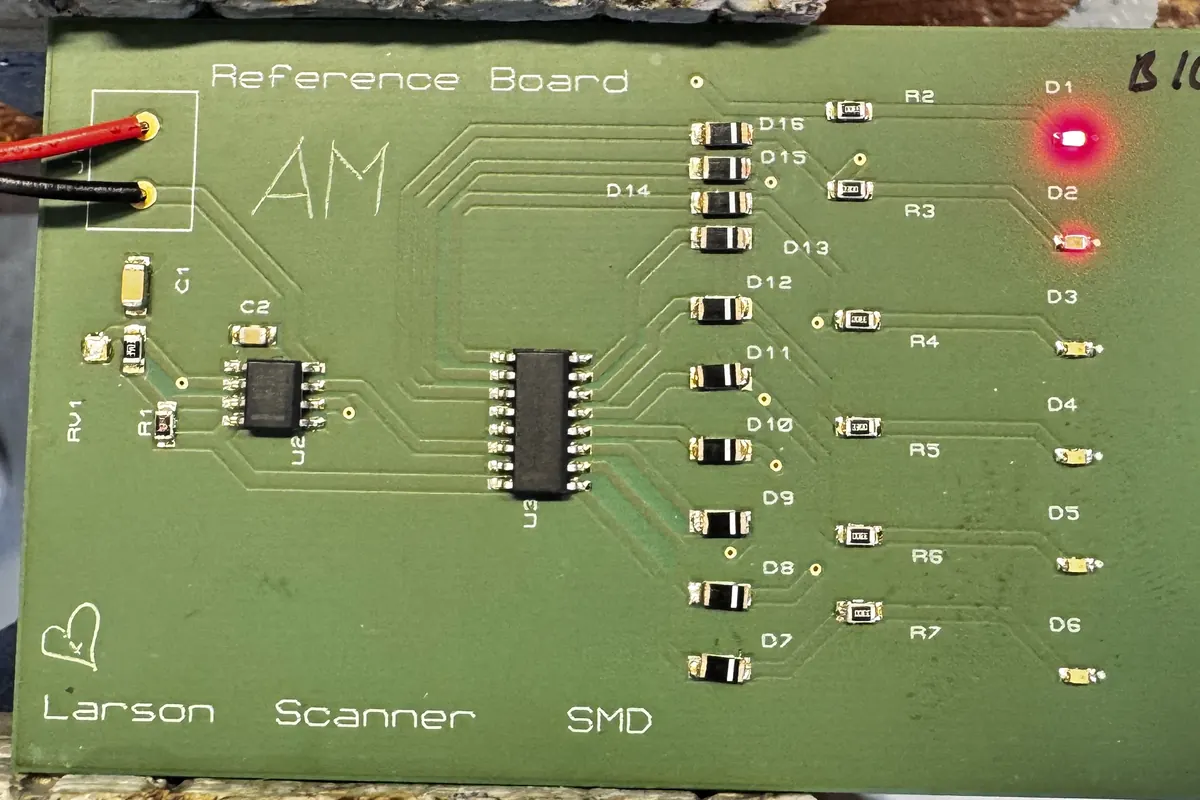 Manufactured surface-mount Larson Scanner PCB with two LEDs lit.